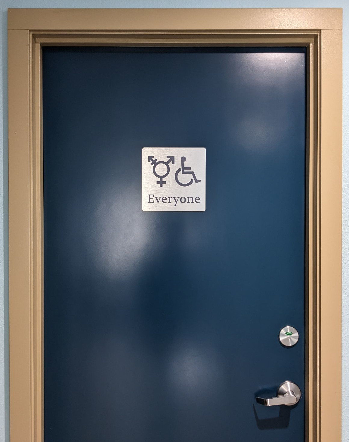 Our inclusive bathroom sign on the door of our clinic bathroom.